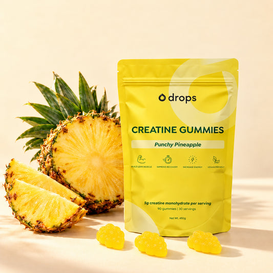 Drops Punchy Pineapple creatine gummies pouch with fruit and three gummies.